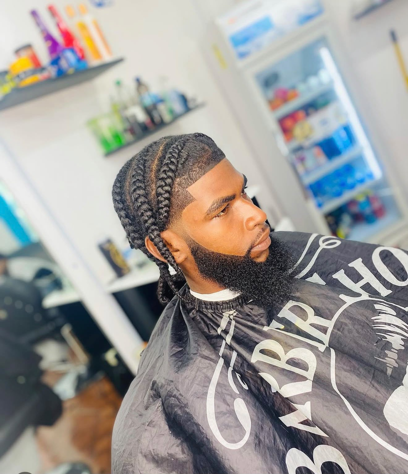 Client with neat cornrows and sharp beard lineup