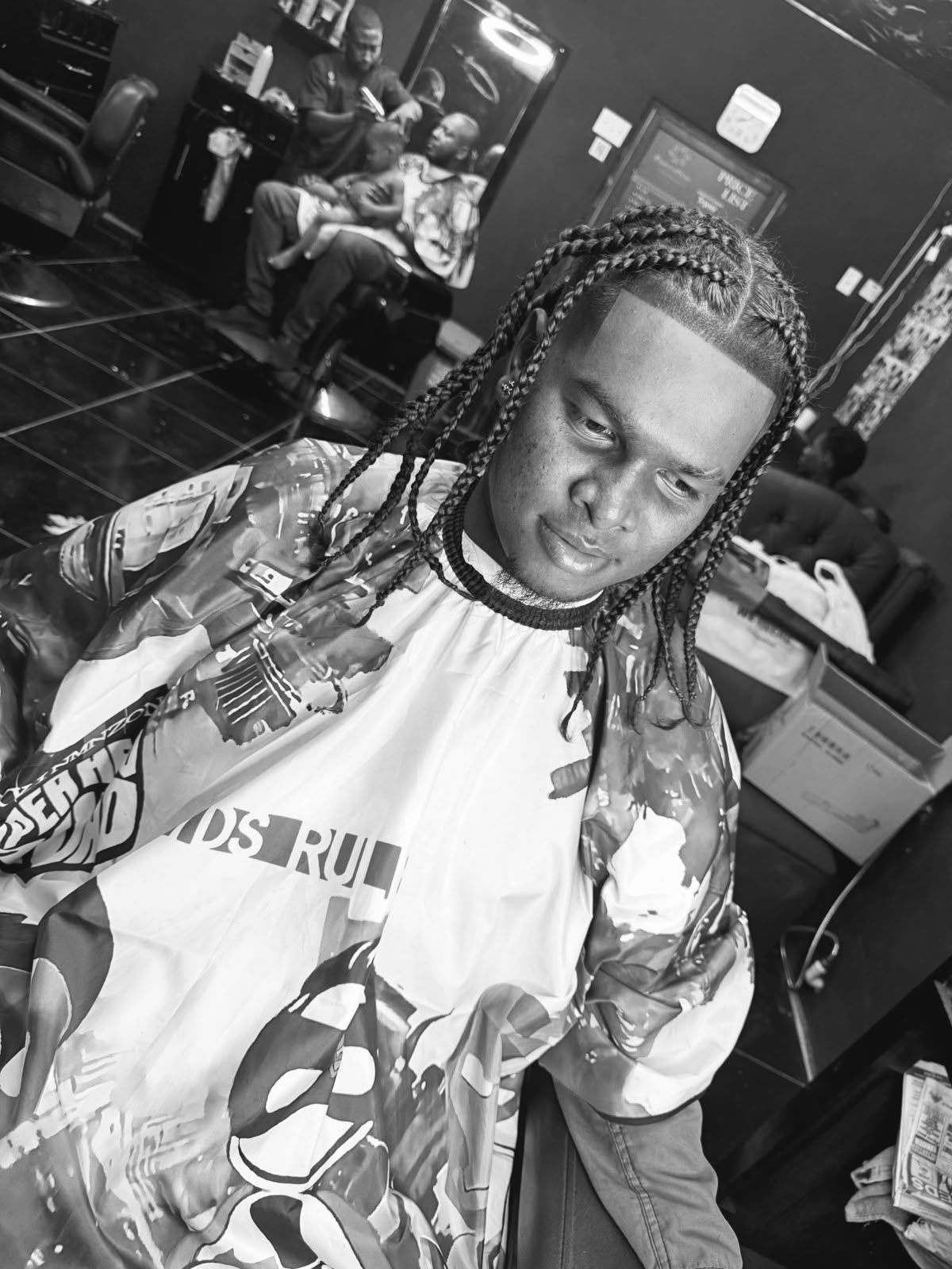 Finished braided hairstyle in a black and white barbershop portrait