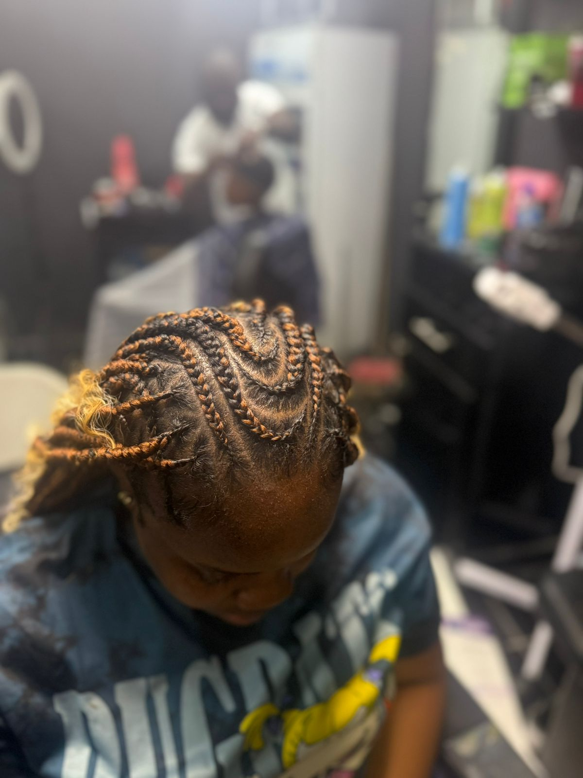 Front angled view of patterned braids with warm brown highlights
