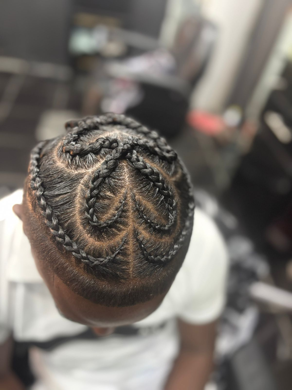 Top view of a detailed braided pattern on short hair